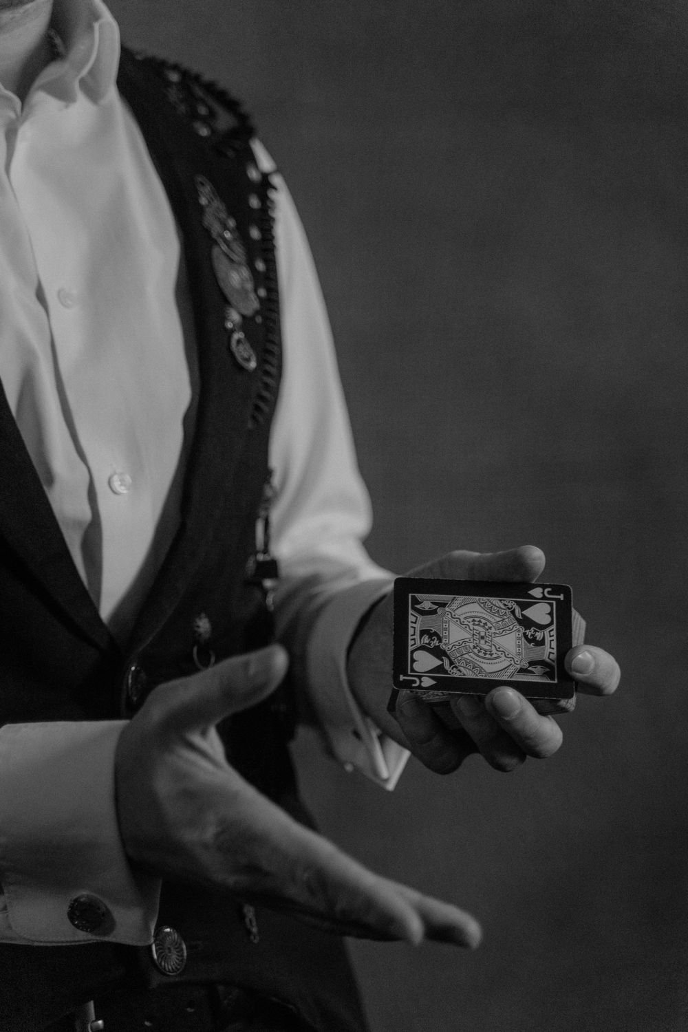 Close-up of a magician's hands performing a card trick